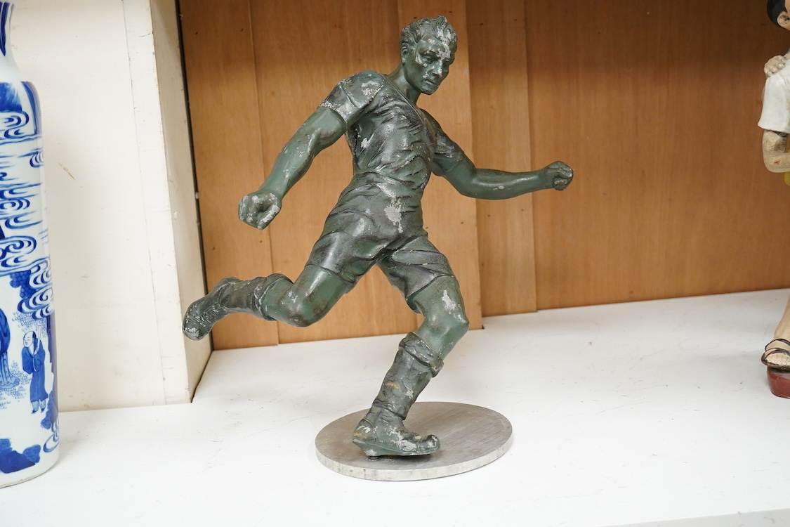 A mid 20th century aluminium cast sculpture of a footballer on stand- 35.5cm wide